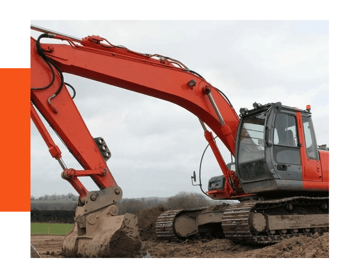 Red excavator during earthworks at construction site.
