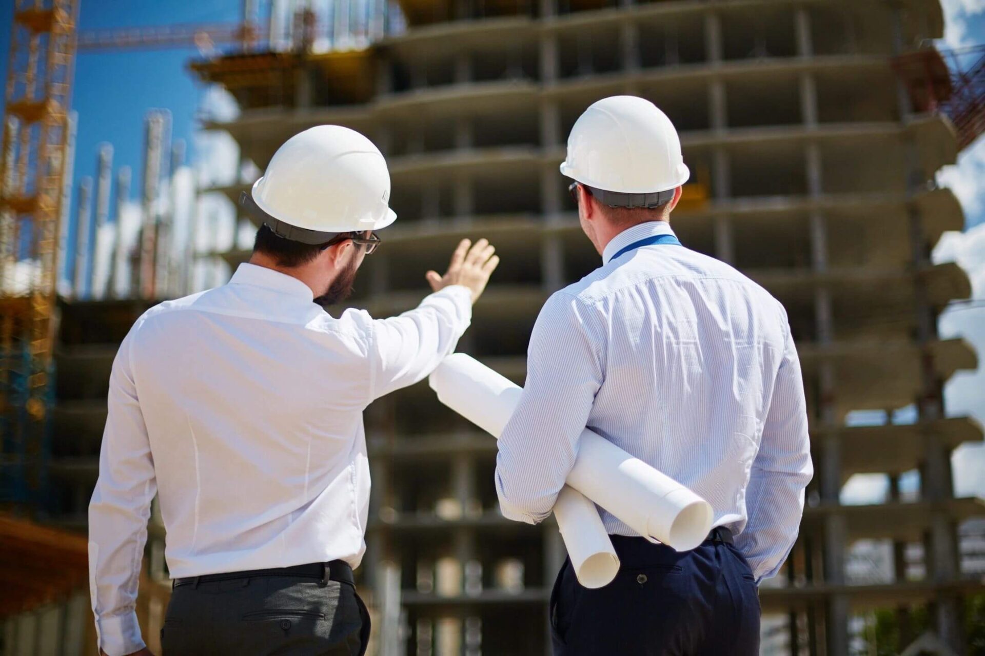 Rear view of architects looking at construction